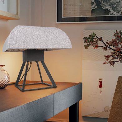 Table lamp with steel-and-textile dome shade on a black geometric base